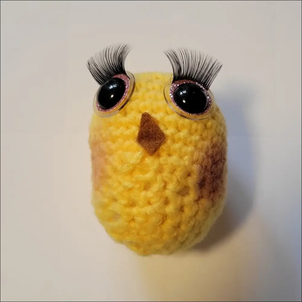 Colorful yellow bird with black eyes on Handcrafted Senior Makes Sea Slug Latte Cup Toy