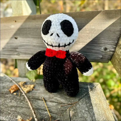 Knitted Skellington doll with a red bow tie, perfect for Halloween fun!