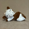 Crocheted cow plush toy on a beige background