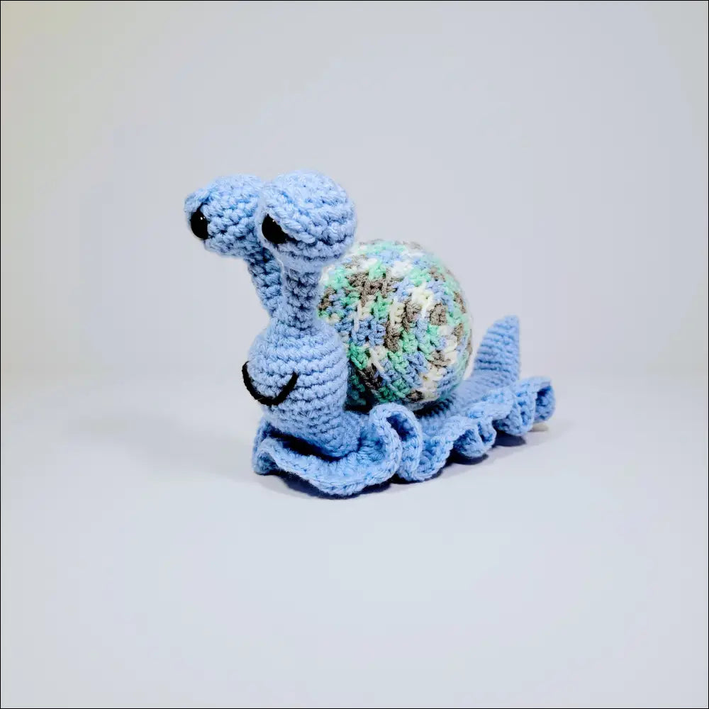 Cute hand-crocheted snails in Green Yellow and Grey Pink with a stuffed turtle on white