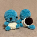 Blue plush toy resembling a character from a popular franchise on a beige background