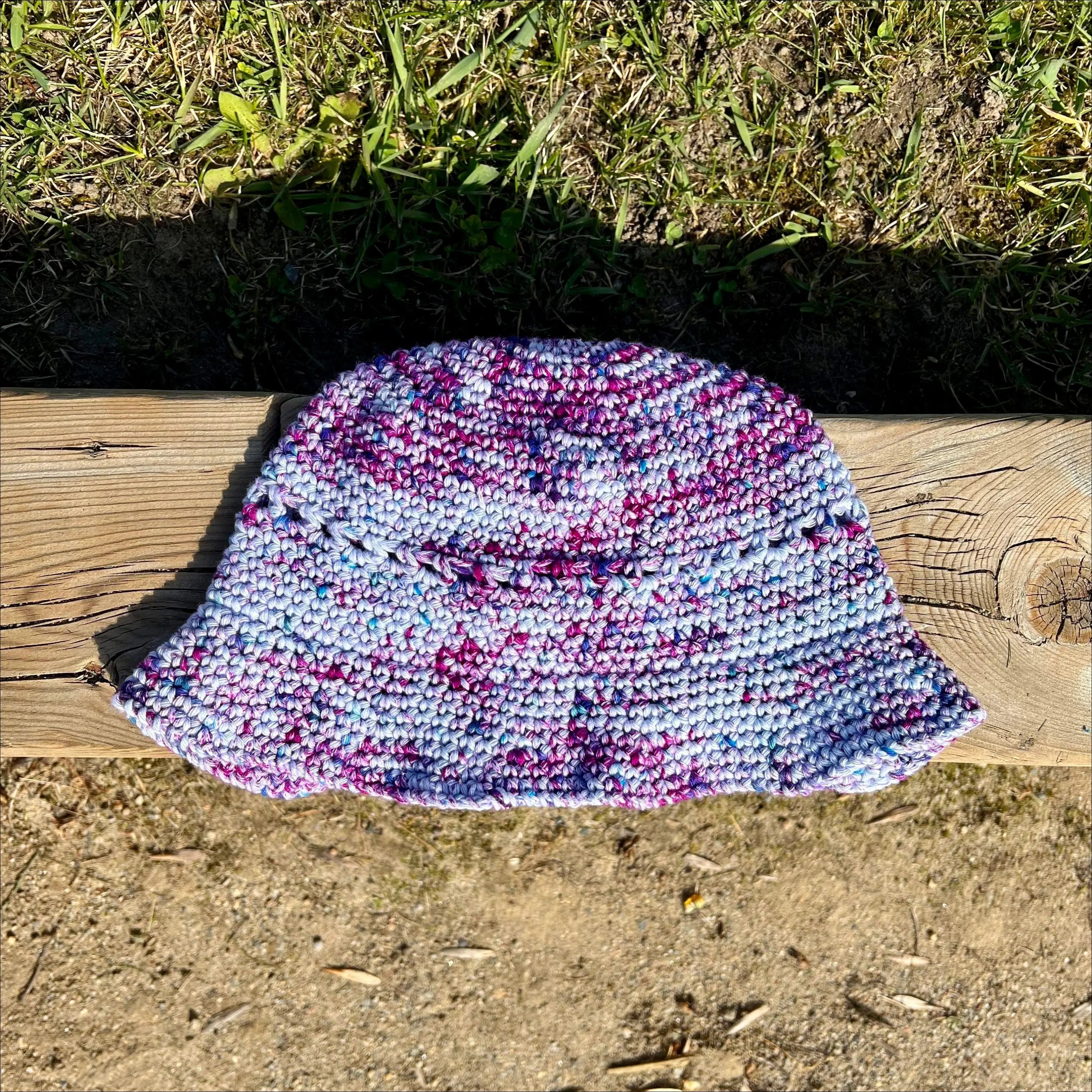 Crocheted bucket hat in purple, blue, and white for summer fun bucket adventures