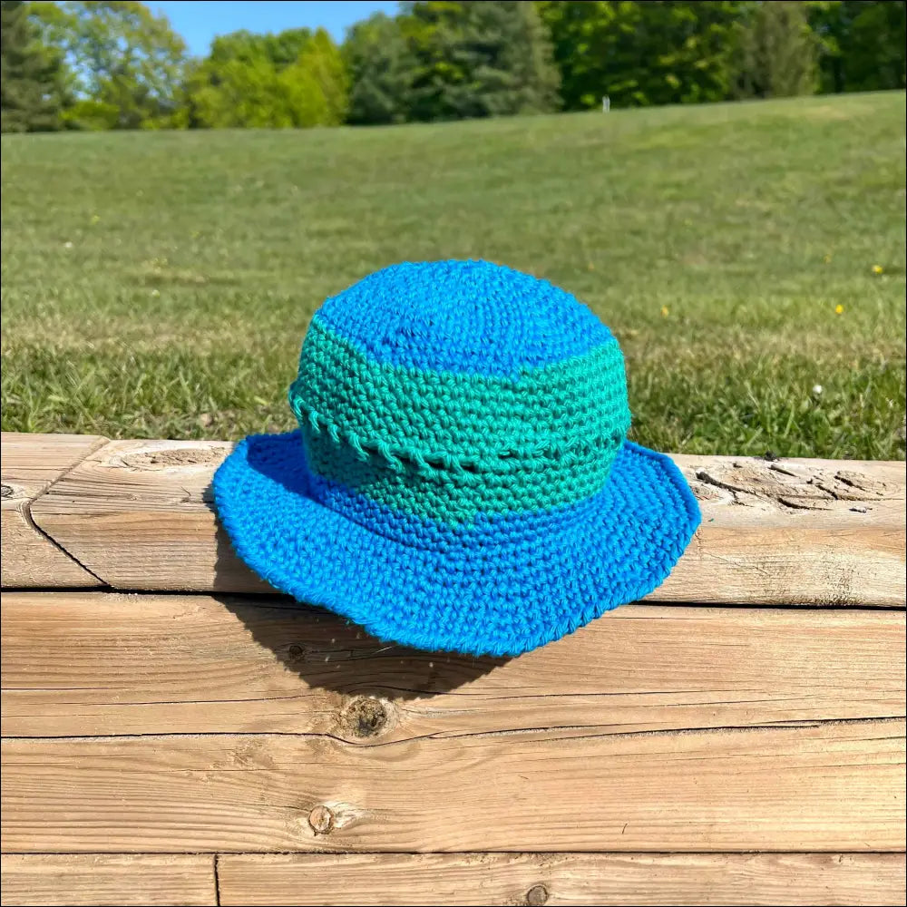 Blue and green crocheted bucket hat from Summer Fun Bucket collection in cream, peach, teal