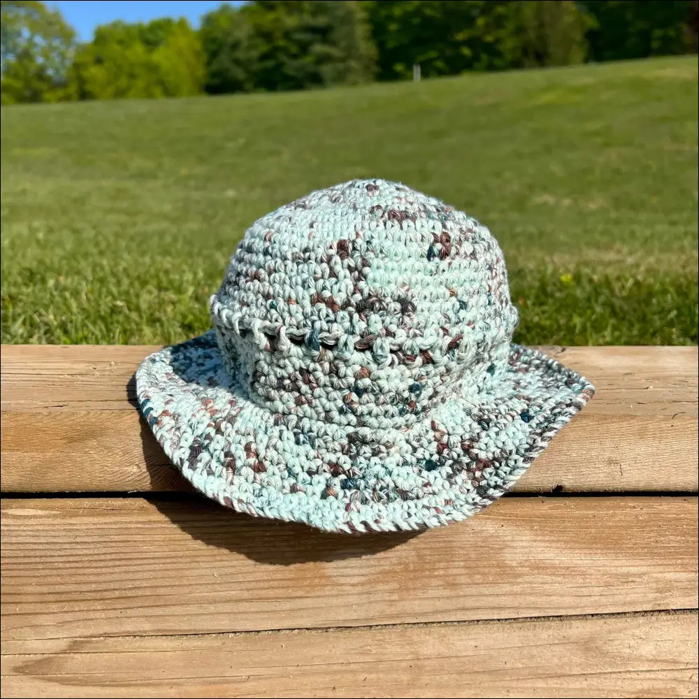 Knitted sun hat in a blue-green and brown pattern from Summer Fun Bucket Hats collection