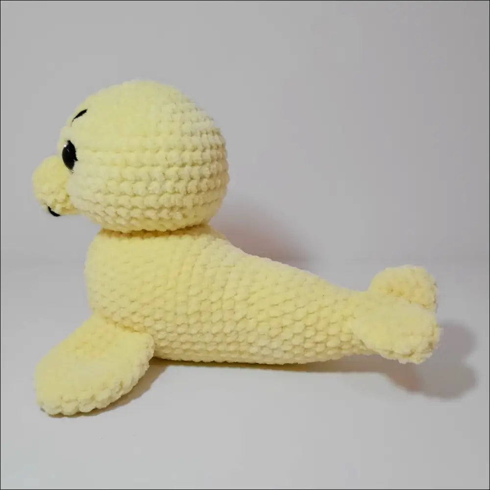 Yellow Sweet Seals fuzzy friend plush toy on a white surface, perfect for playtime fun