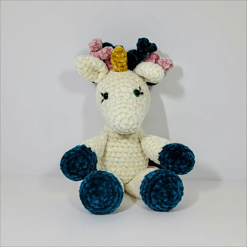 Crocheted unicorn plush toy with colorful mane, perfect for cuddling and fun at checkout