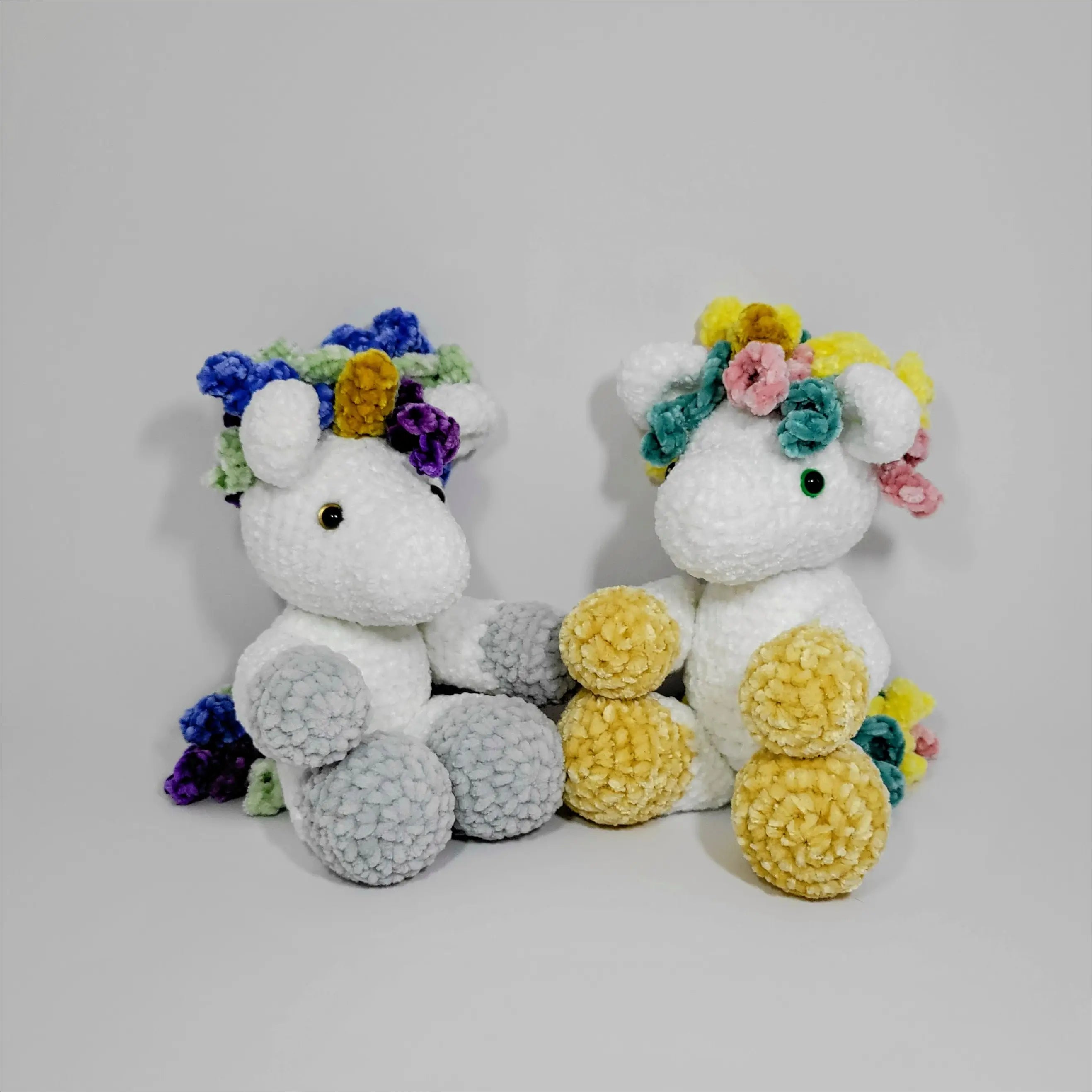 Two cute unicorn plushies with floral crowns, perfect for snuggles at checkout