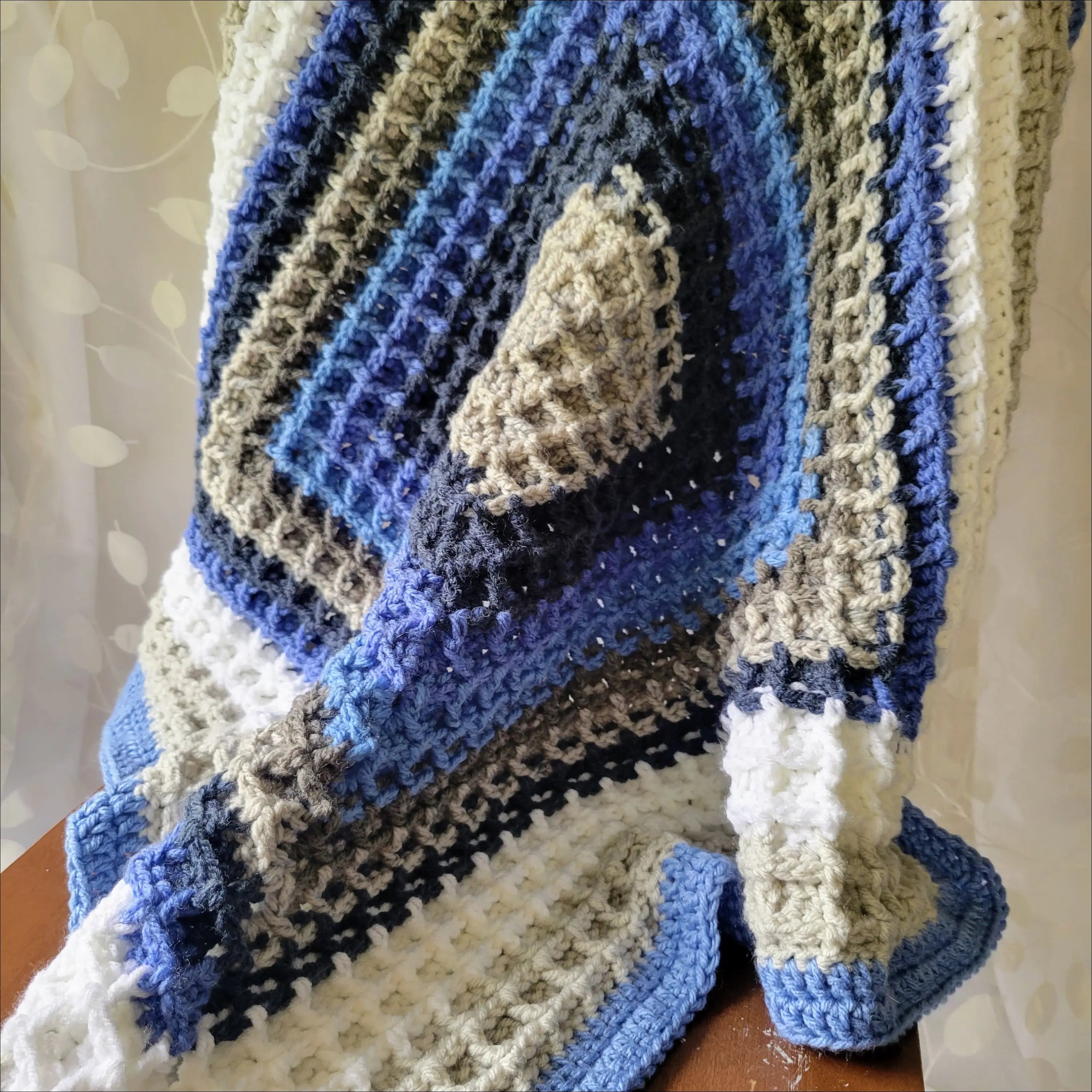 Waffle Baby Blanket featuring cozy blue, white, and gray geometric patterns