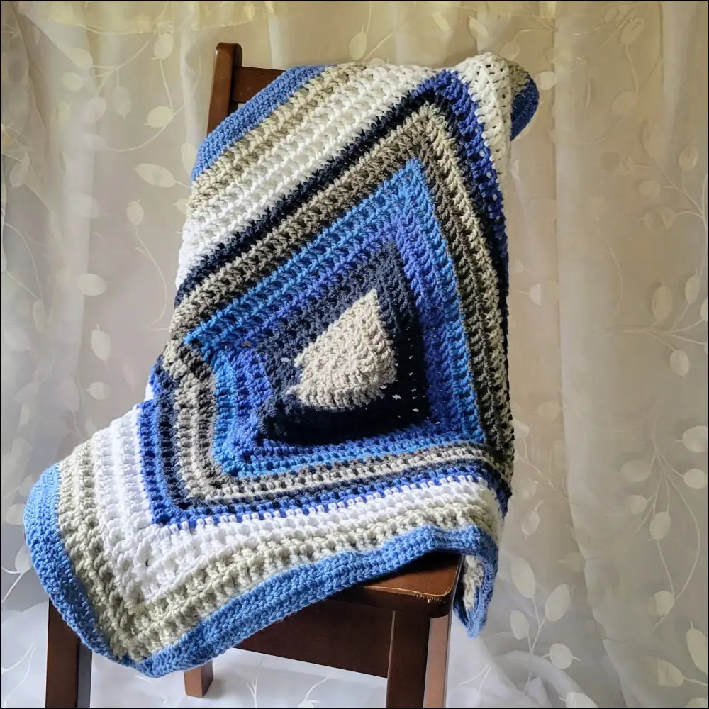 Cozy Waffle Baby Blanket featuring a blue, white, and gray diamond pattern on chair