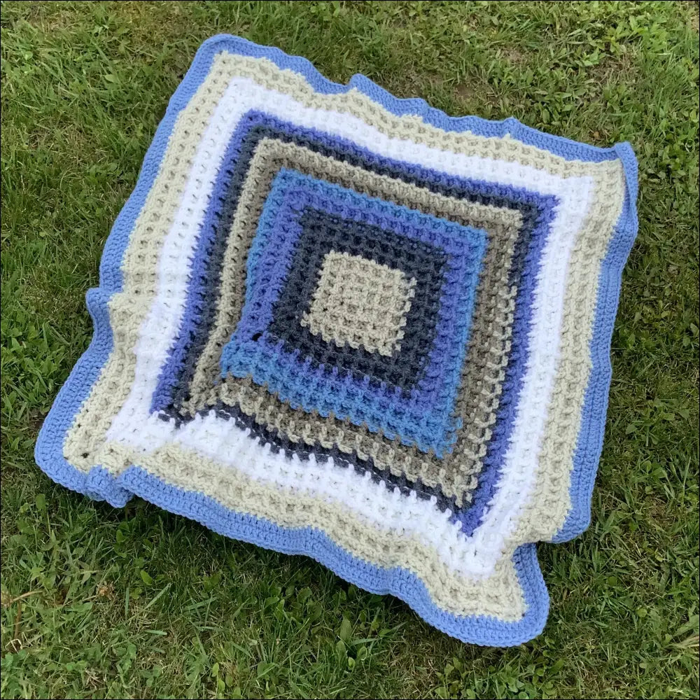 Cozy Waffle Baby Blanket featuring blue, white, and gray concentric patterns