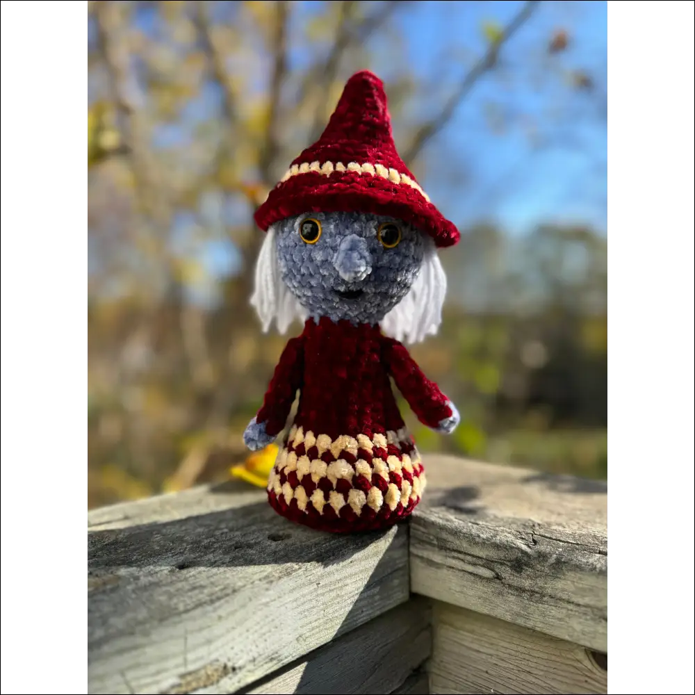 Crocheted doll in red and yellow outfit, perfect for Purple Plush witches decor