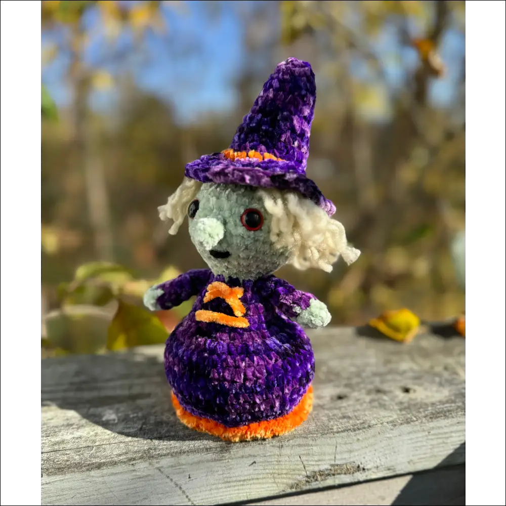 Crocheted witch doll in purple plush outfit, perfect for spooky Halloween decor