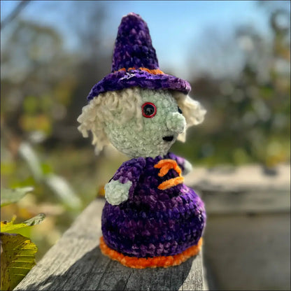 Crocheted purple plush witch doll with a red eye, perfect for Halloween decor