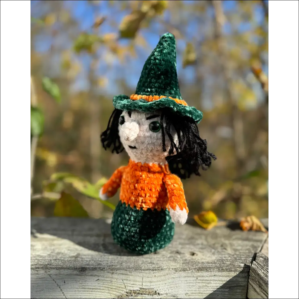 Knitted witch doll in green hat and orange sweater for Purple Plush Halloween decor