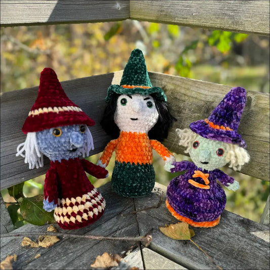 Three colorful witches in purple plush hats for spooky Halloween decor