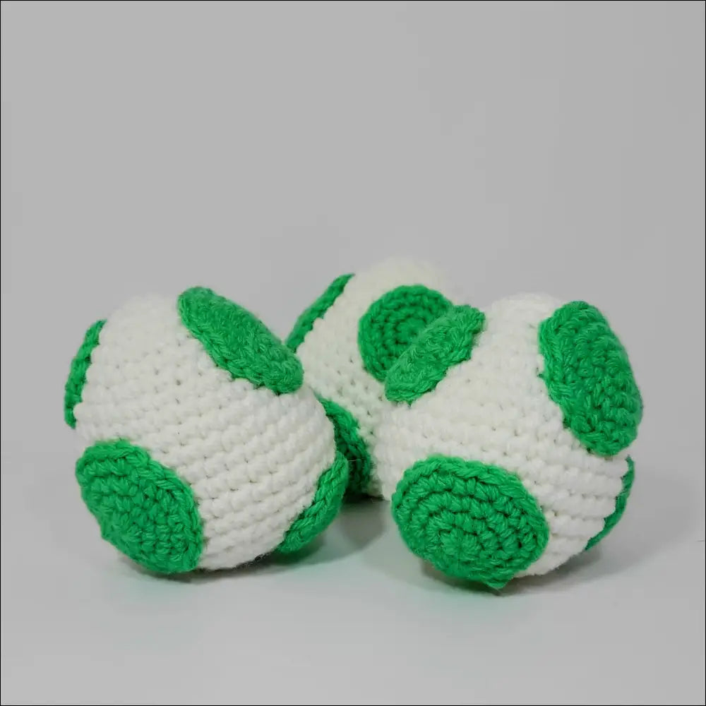 A pair of crochet soccer balls from Cute Yoshi Eggs for Super Mario fans