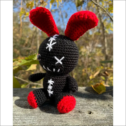 Crocheted black Zombie Bunny toy with red ears and feet for fun adventures